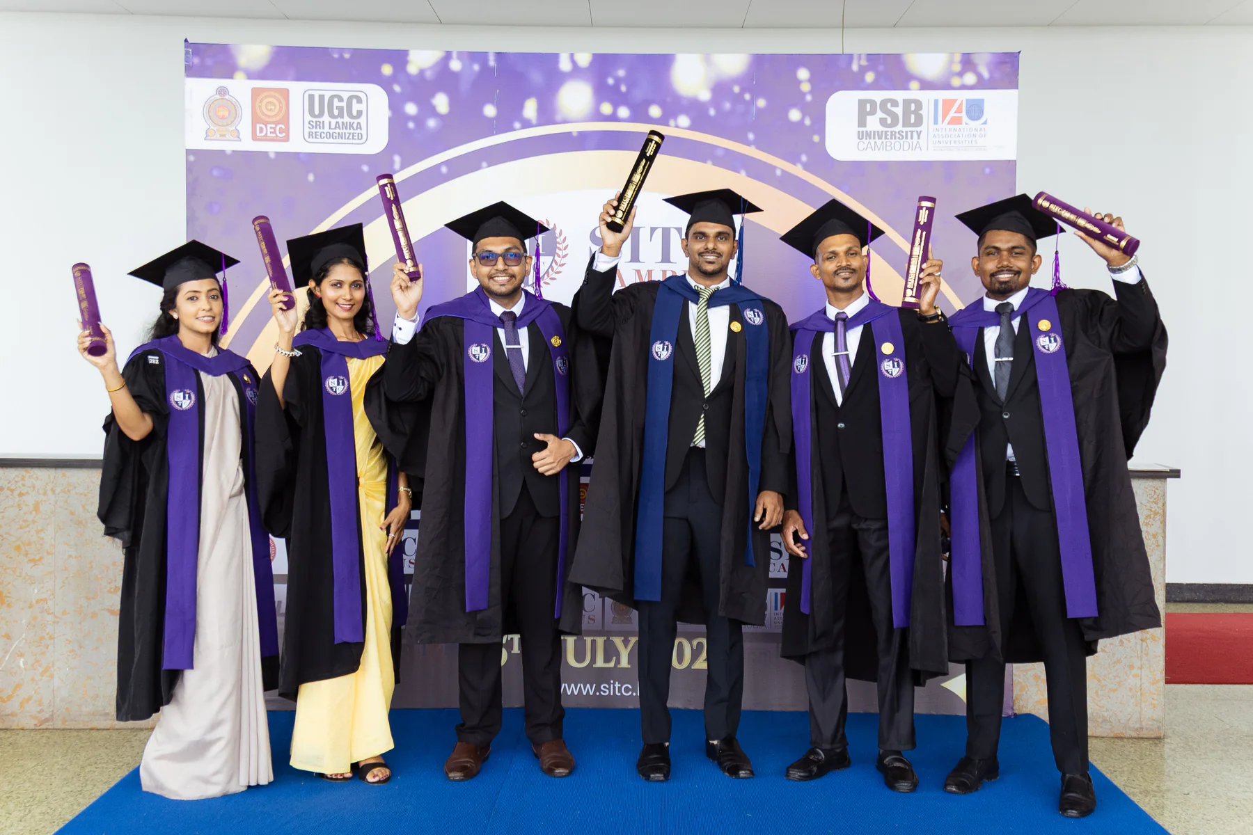 A group of graduates smiling together with their certificates