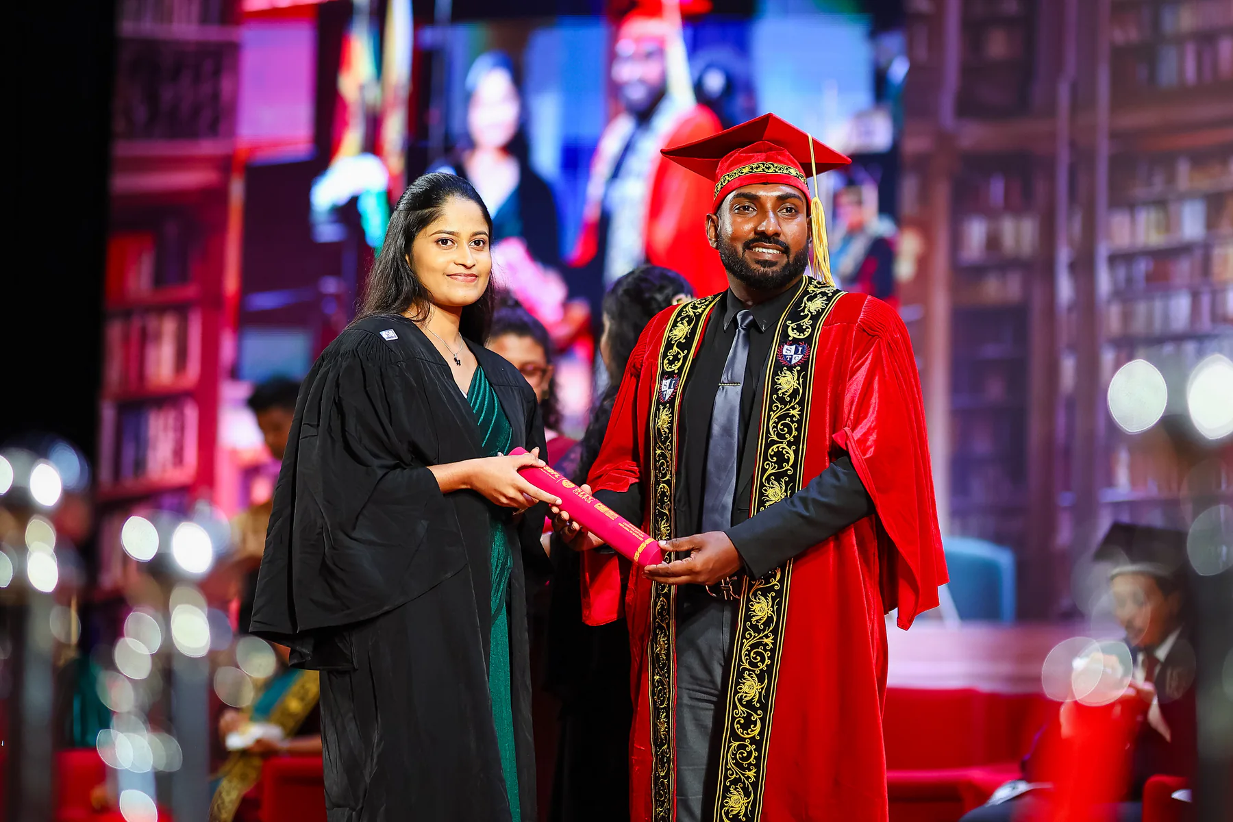 A graduate receiving a certificate during the ceremony