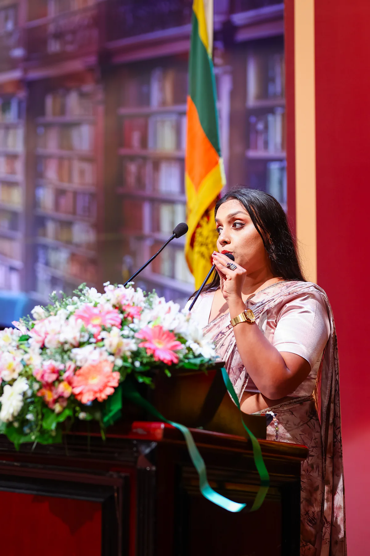A speaker addressing the convocation from the flower-lined podium