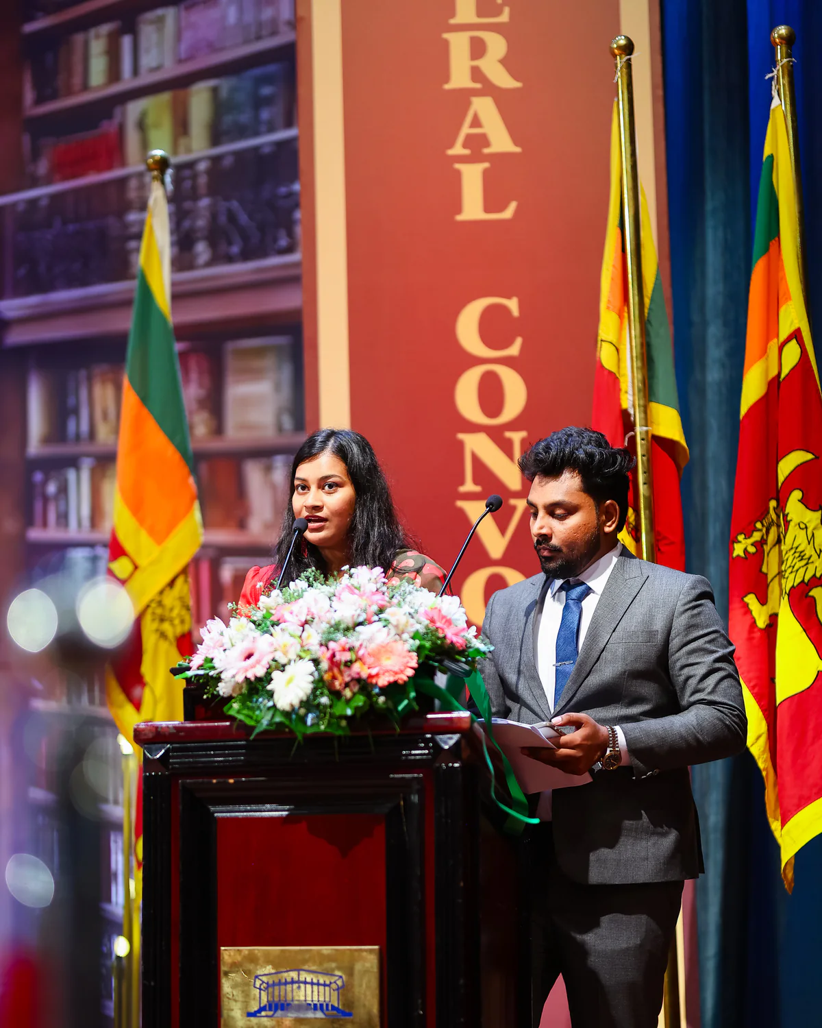 A speaker addressing graduates and guests from the convocation podium