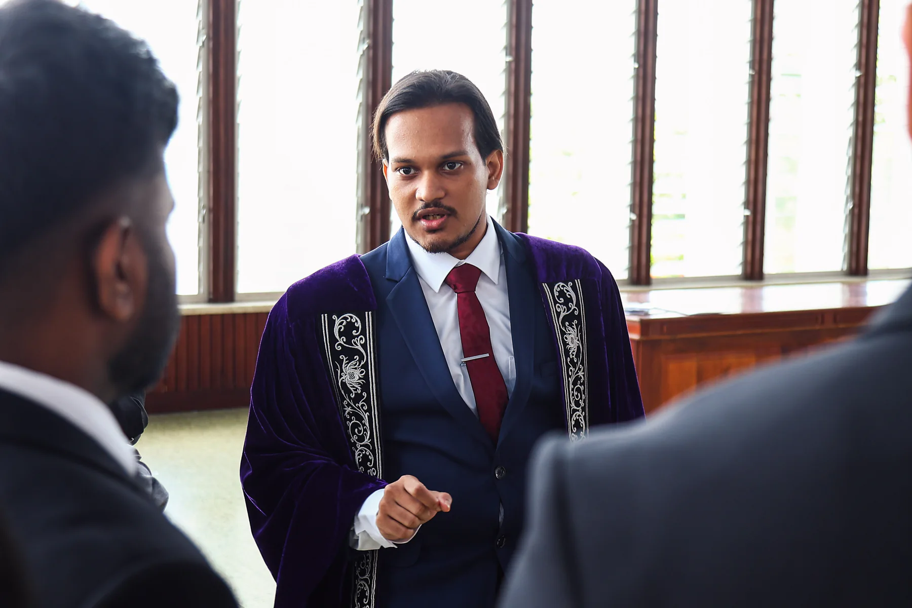 Graduates and guests gathering in conversation before the ceremony